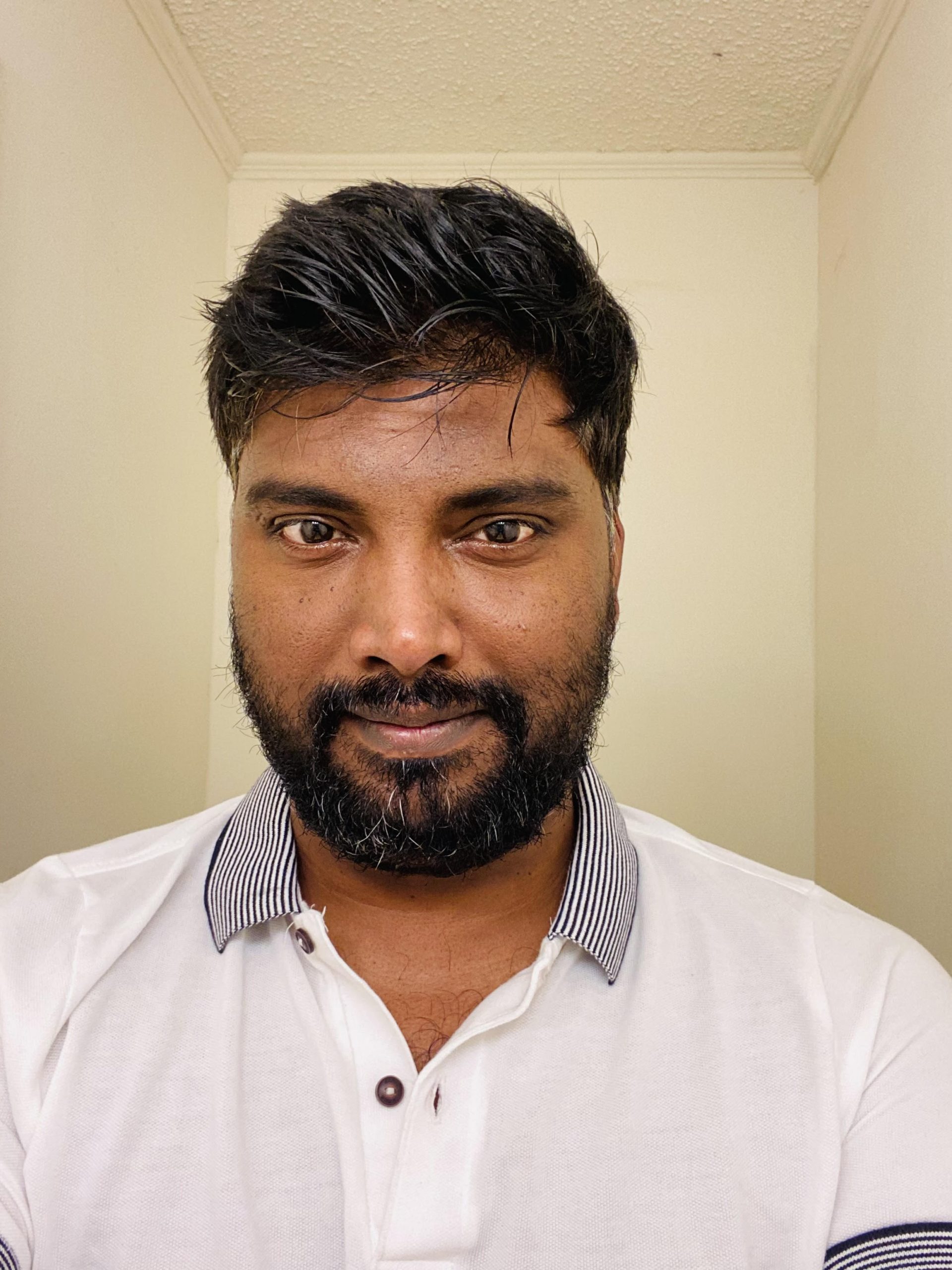 Headshot photograph of graduate student Sarangan Balasubramaniam, he is tan-skinned, dark-haired, with a beard, wearing a polo shirt