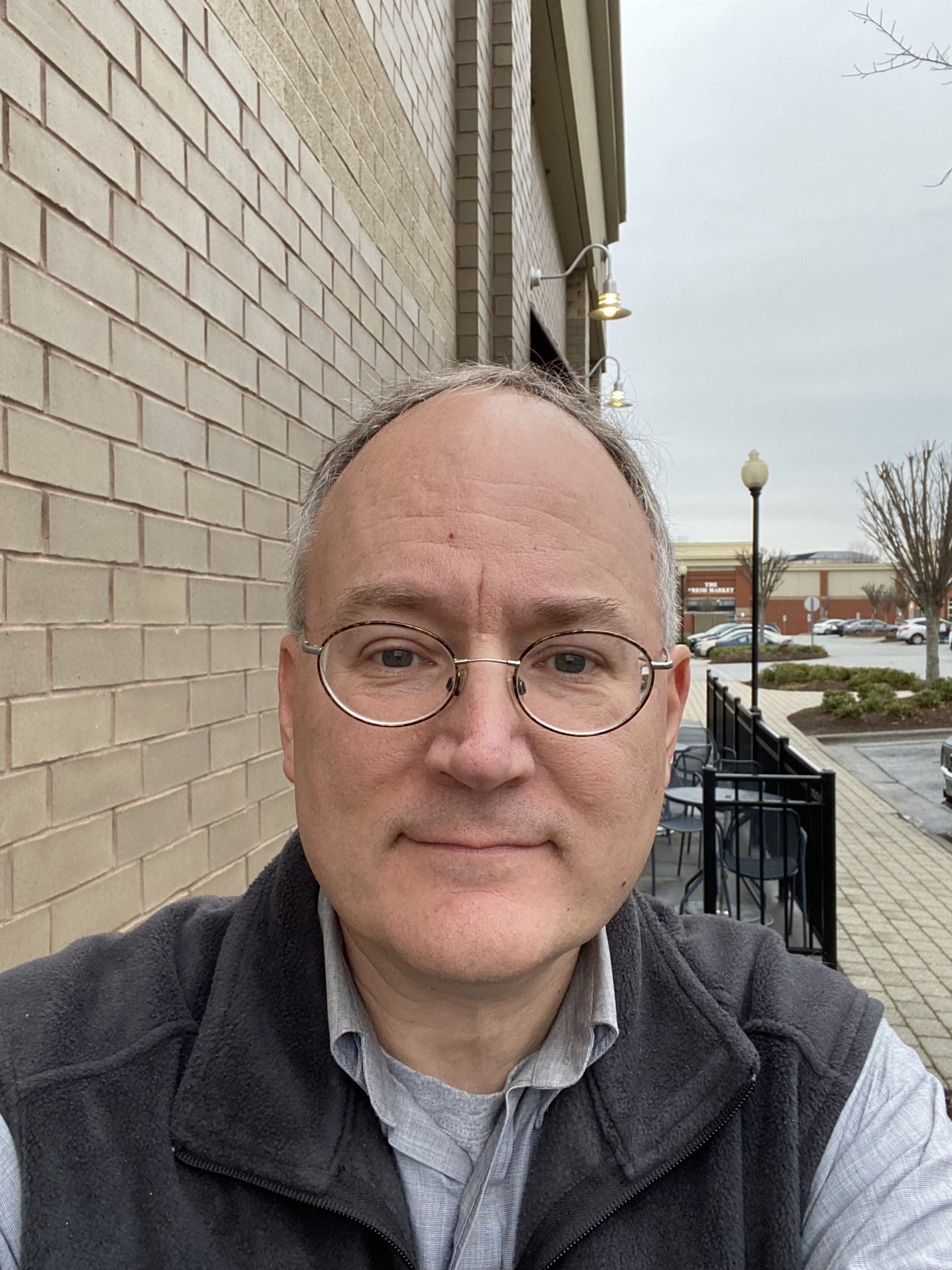 A headshot photograph of Eric Hardin, a man wearing glasses facing forward to the camera